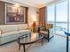 Cozy living room features comfortable seating and a large window with captivating city views at 135 E Harmon Ave # 2104, Las Vegas, NV 89109