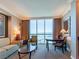 Relaxing living area with neutral decor and a window showcasing impressive city views at 135 E Harmon Ave # 2104, Las Vegas, NV 89109