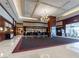 Elegant hotel lobby with marble floors, dark wood accents, and a chandelier at 135 E Harmon Ave # 2104, Las Vegas, NV 89109