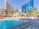 Resort-style pool with water features, lounge chairs, palm trees, and city views, for relaxation and entertainment at 135 E Harmon Ave # 2104, Las Vegas, NV 89109