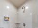 Bright shower with tiled walls, built in shelf, and modern shower head at 135 E Harmon Ave # 2104, Las Vegas, NV 89109