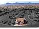 An aerial perspective of a single-Gathering home with desert landscaping and a paved driveway at 1405 Bugle Boy Dr, Henderson, NV 89014