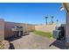 The backyard features a stainless steel grill, a small patch of turf, and a brick-paved area at 1405 Bugle Boy Dr, Henderson, NV 89014