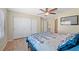 Comfortable bedroom with a ceiling fan, closet, and a window overlooking the backyard at 1405 Bugle Boy Dr, Henderson, NV 89014
