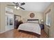Cozy bedroom with hardwood floors, ceiling fan, and stylish furnishings at 1405 Bugle Boy Dr, Henderson, NV 89014