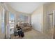 Cozy room with bright windows, plush carpeting, and a comfortable sofa at 1405 Bugle Boy Dr, Henderson, NV 89014