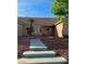 Inviting home entrance with a well-maintained yard and decorative rock features at 1405 Bugle Boy Dr, Henderson, NV 89014