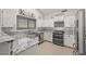 White kitchen featuring stainless steel appliances and granite countertops at 1405 Bugle Boy Dr, Henderson, NV 89014