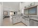 Bright kitchen with white cabinetry, stainless steel sink, and granite countertops at 1405 Bugle Boy Dr, Henderson, NV 89014