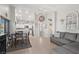 Open concept living space with kitchen view featuring tile floors and a cozy gray sofa at 1405 Bugle Boy Dr, Henderson, NV 89014