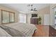 Spacious main bedroom featuring wood floors, ceiling fan, and large windows at 1405 Bugle Boy Dr, Henderson, NV 89014