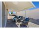 This covered brick patio has comfortable outdoor seating and offers a relaxing retreat at 1405 Bugle Boy Dr, Henderson, NV 89014