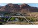 Aerial view of the desert property, outlined to show boundaries and nearby desert mountain scenery at 14525 Heyer Way, Las Vegas, NV 89161