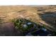 Aerial shot of the property, capturing mountain views and lush greenery, complete with desert landscape at 14525 Heyer Way, Las Vegas, NV 89161