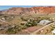 Wide aerial view of property, desert landscape, and surrounding mountains in Red Rock at 14525 Heyer Way, Las Vegas, NV 89161
