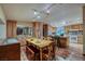 Spacious kitchen and dining area with wooden cabinets, an island, and ample counter space, perfect for entertaining at 14525 Heyer Way, Las Vegas, NV 89161