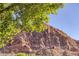 Striking view of a rugged mountain under a clear blue sky with green foliage at 14525 Heyer Way, Las Vegas, NV 89161