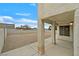 A blank backyard, fenced in on all sides, with a small covered patio at 15 Richland Acres Ct, Henderson, NV 89074
