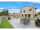 Landscaped backyard with a fire pit seating area, patio dining table and chairs, and a built-in barbecue grill at 15 Richland Acres Ct, Henderson, NV 89074