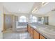 Well-lit bathroom features dual sinks, glass enclosed shower, and soaking tub at 15 Richland Acres Ct, Henderson, NV 89074