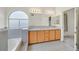 Bright bathroom with dual sinks, tile flooring, large mirrors, and a soaking tub at 15 Richland Acres Ct, Henderson, NV 89074