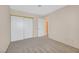 A bedroom with neutral walls and carpet with a view into the hallway, and a closet with sliding doors at 15 Richland Acres Ct, Henderson, NV 89074