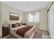 Virtually staged bedroom featuring a large bed, nightstands, and natural light at 15 Richland Acres Ct, Henderson, NV 89074