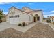 Close up of home with desert landscaping, red tile roof and an arched entryway at 15 Richland Acres Ct, Henderson, NV 89074