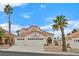 Charming two-story home with desert landscaping, a red tile roof, and a three-car garage at 15 Richland Acres Ct, Henderson, NV 89074