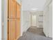 Well-lit hallway with hardwood cabinetry and plush carpeting for a comfortable and inviting space at 15 Richland Acres Ct, Henderson, NV 89074