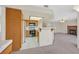 Open concept kitchen features tile flooring, wooden cabinets, and a breakfast bar overlooking living area at 15 Richland Acres Ct, Henderson, NV 89074
