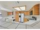 Bright kitchen showcasing tiled countertops, wooden cabinets, and modern appliances at 15 Richland Acres Ct, Henderson, NV 89074