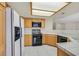 Functional kitchen features light wood cabinetry, tile countertops, and modern appliances for convenient cooking at 15 Richland Acres Ct, Henderson, NV 89074