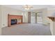 Living room featuring a fireplace, sliding glass doors, and neutral carpeting at 15 Richland Acres Ct, Henderson, NV 89074