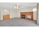 Spacious living room with a brick fireplace, wet bar, and ceiling fan at 15 Richland Acres Ct, Henderson, NV 89074