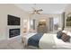 Staged main bedroom with a cozy fireplace, ceiling fan and large windows for ample natural light at 15 Richland Acres Ct, Henderson, NV 89074