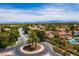 Expansive aerial of the residential area showcasing palm-lined streets, lush landscaping, and well-maintained homes at 1712 Warrenville St, Las Vegas, NV 89117