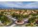 Stunning aerial view of a Primary-planned community featuring well-manicured landscaping and a modern roundabout at 1712 Warrenville St, Las Vegas, NV 89117