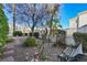 Charming backyard with mature trees, shrubs and a rock garden at 1712 Warrenville St, Las Vegas, NV 89117