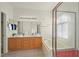 Bright bathroom featuring double sinks, a soaking tub, and a separate shower stall with glass doors at 1712 Warrenville St, Las Vegas, NV 89117