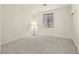 Empty bedroom featuring carpet, a double door closet, natural light, and a floor lamp at 1712 Warrenville St, Las Vegas, NV 89117