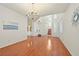 Open-concept living room with hardwood floors, decorative lighting, and staircase views at 1712 Warrenville St, Las Vegas, NV 89117