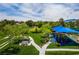 Aerial view of neighborhood playground with colorful equipment, picnic tables, and lush green space at 1712 Warrenville St, Las Vegas, NV 89117