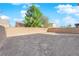 Spacious backyard with fresh dirt, framed by a block wall and a few mature trees at 1836 Soto Ln, North Las Vegas, NV 89032