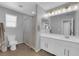 Bright bathroom with a double sink vanity, framed mirror, and shower with curtain at 1836 Soto Ln, North Las Vegas, NV 89032