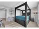 Comfortable bedroom featuring a four-poster bed, neutral walls, and window views at 1836 Soto Ln, North Las Vegas, NV 89032