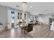 Elegant dining area with modern chandelier, view of the living room, and access to the patio at 1836 Soto Ln, North Las Vegas, NV 89032
