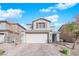 Charming two-story home features a two-car garage, brick driveway, and manicured landscaping at 1836 Soto Ln, North Las Vegas, NV 89032