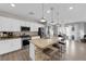 Modern kitchen features white cabinets, stainless steel appliances, and an island with seating at 1836 Soto Ln, North Las Vegas, NV 89032