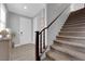 Welcoming home entryway featuring the carpeted staircase with wooden handrail at 1836 Soto Ln, North Las Vegas, NV 89032